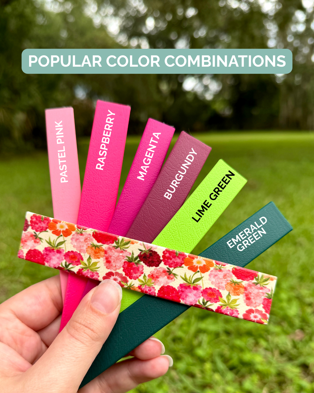 Color swatches with labeled colors held by a hand against a grassy background