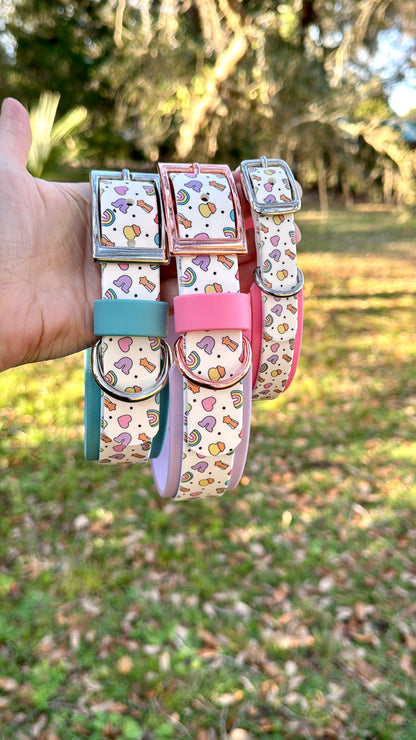 Set of colorful dog collars with Lucky Charm Pattern held in front of a natural background
