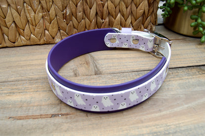 Lilac Biothane dog collar with white ghosts and black stars on wooden surface