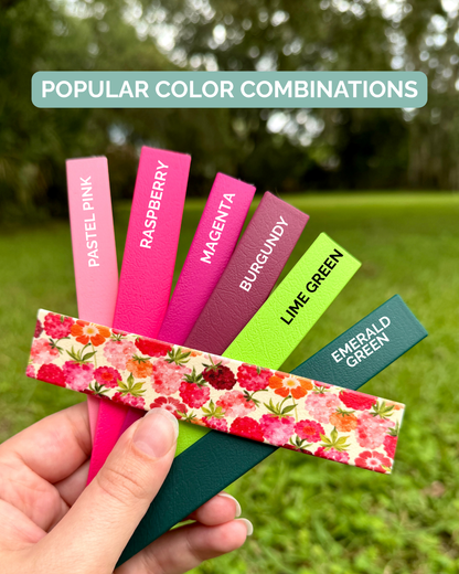 Color swatches with labeled colors held by a hand against a grassy background