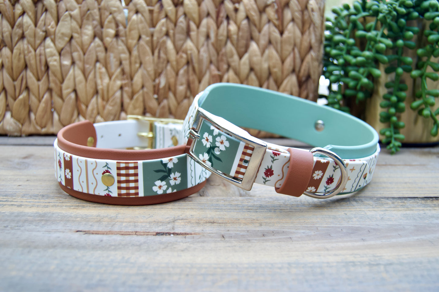 2 biothane dog collars with a striping floral design on a wooden surface with a natural basket and plant in the backgrounds