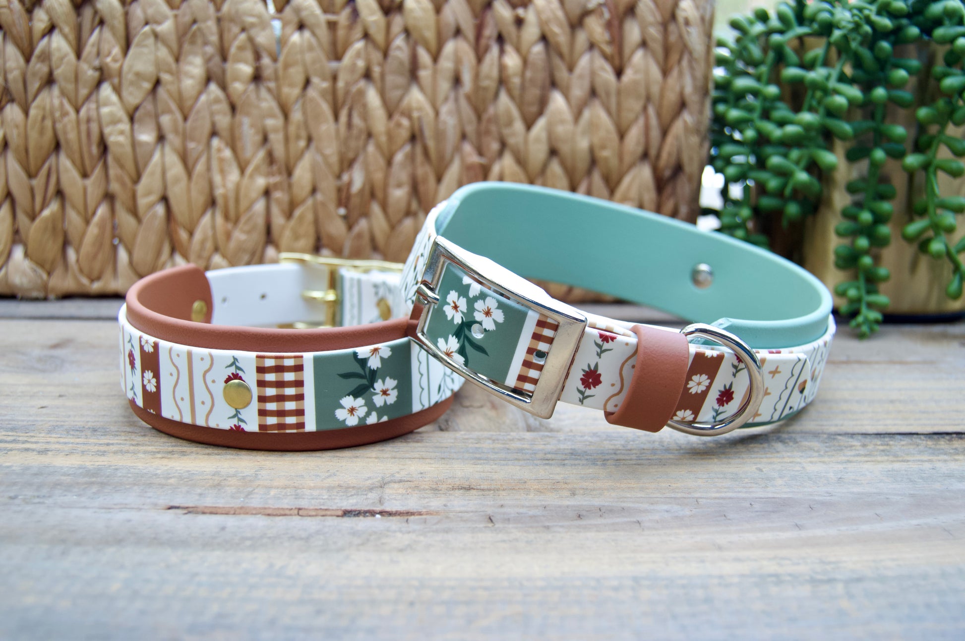 2 biothane dog collars with a striping floral design on a wooden surface with a natural basket and plant in the backgrounds