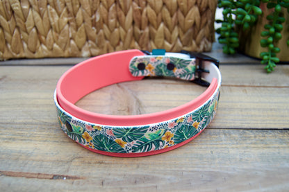 Floral-patterned dog collar with coral accent on a wooden surface