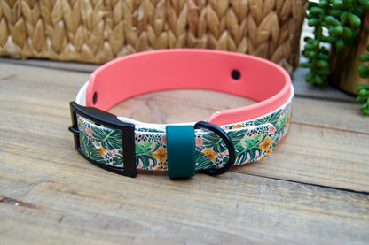 Floral biothane patterned dog collar with a coral accent on a wooden surface